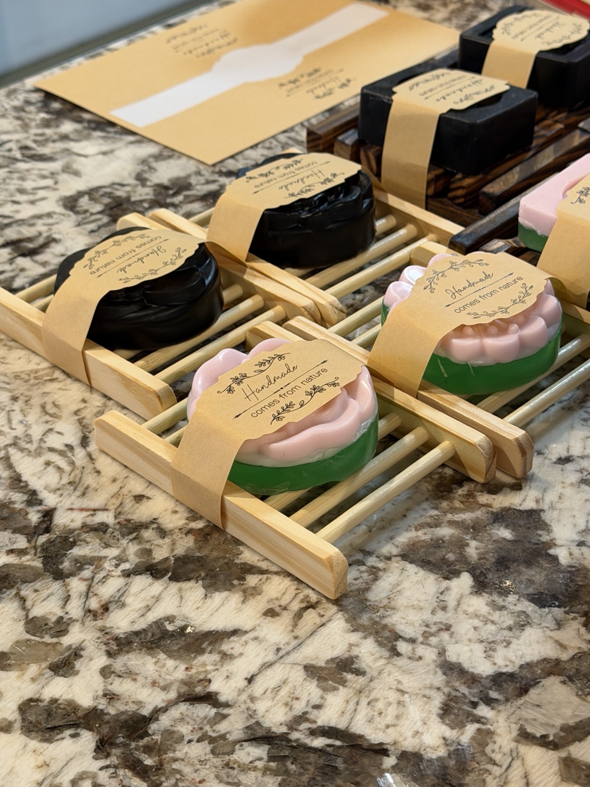 Handmade Sud Buds soaps on bamboo soap holders
